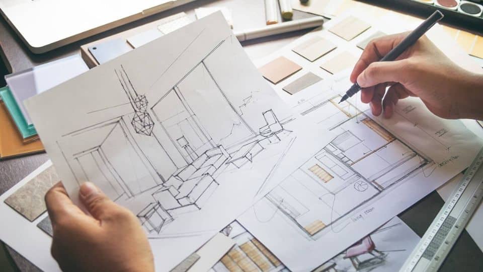 Designer Creating a Black Pen Drawing of a Living Room
